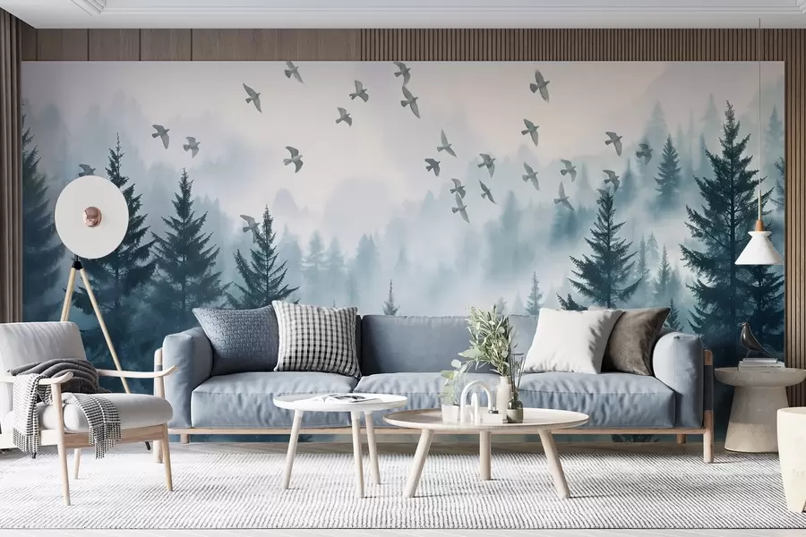 Fototapet Lugn dimmig skog med träd i blå nyanser och en flock fåglar som flyger i skyn  w08664